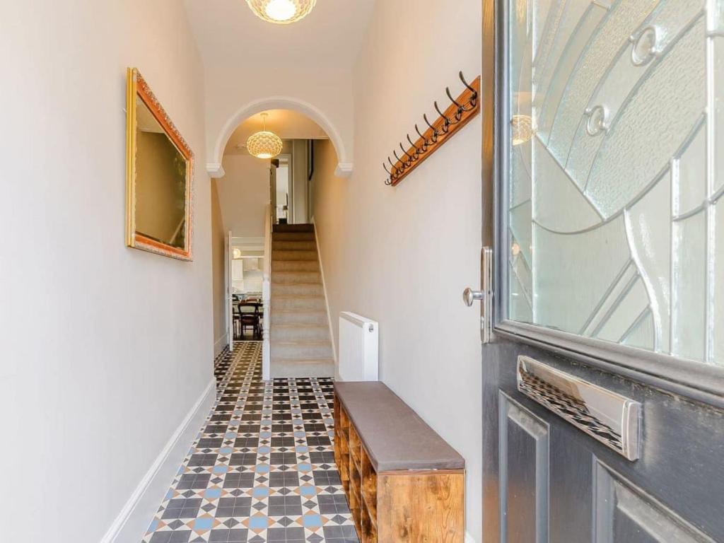 a hallway with a door and a tiled floor at Walpole FRONT House sleeps 13-15 in Margate