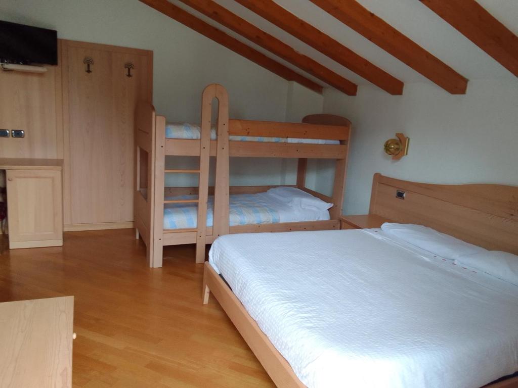 Postel nebo postele na pokoji v ubytování Hotel Al Caminetto