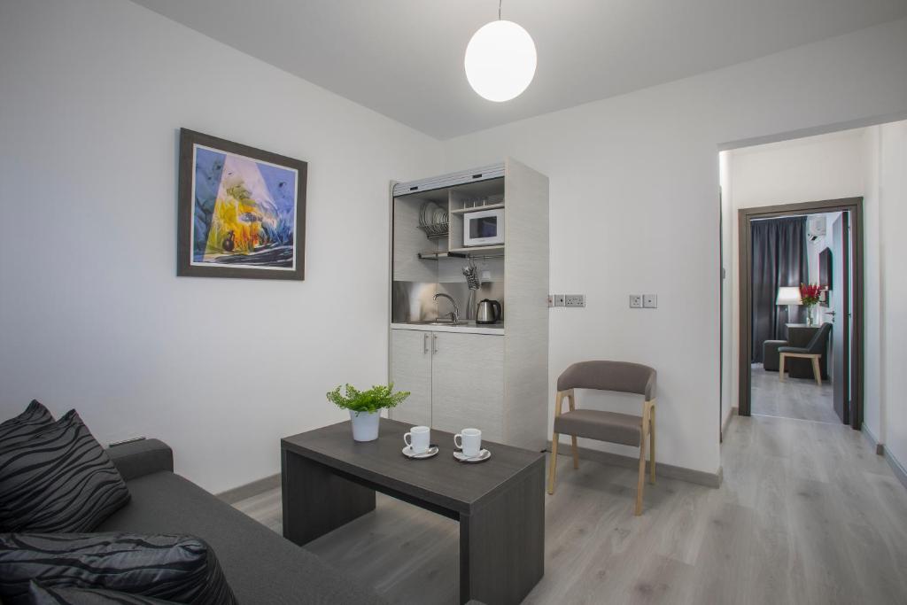 a living room with a couch and a table at Blazer Residence in Larnaka