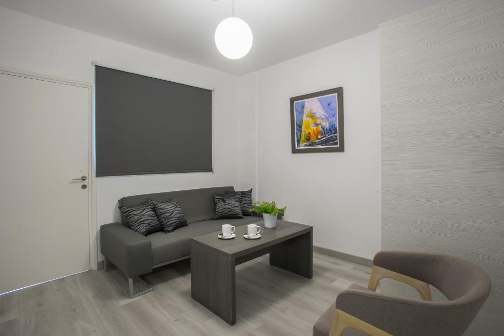 a living room with a couch and a table at Blazer Residence in Larnaka