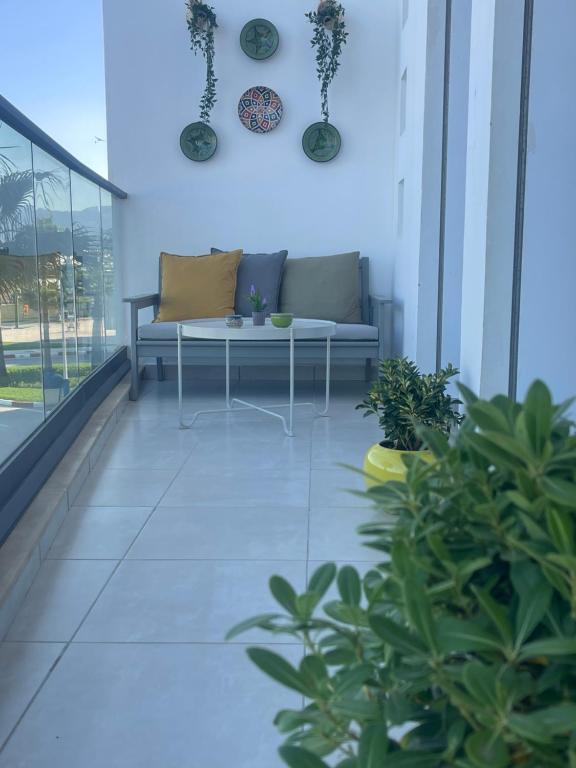 a living room with a couch and some plants at Al amirat martil luxury only family in Martil
