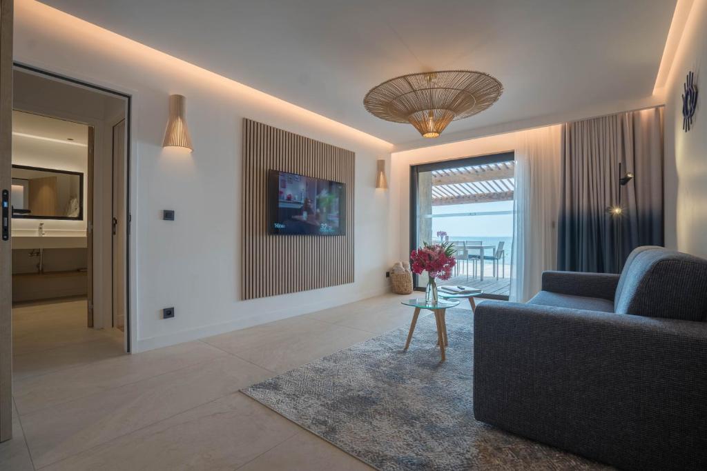 a living room with a couch and a table at EDEN HÔTEL in Sainte-Maxime