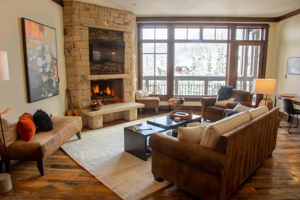 a living room with a couch and a fireplace at AR414B Aspen Dreams Ski-IN OUT in Park City