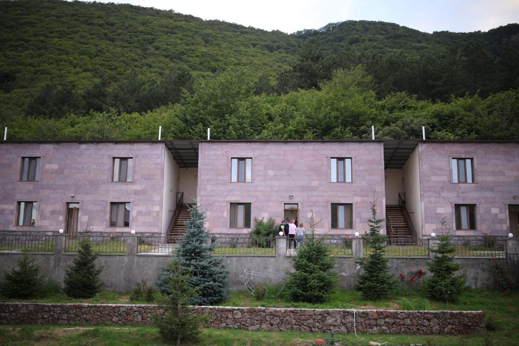 a couple standing in front of a building at Yeghevnut Hotel in Goris