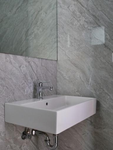 a white sink in a bathroom with a mirror at Vironas Hotel in Himare