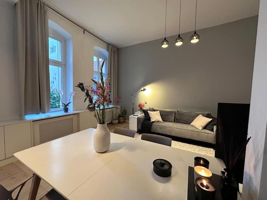 een woonkamer met een witte tafel en een bank bij charming and cozy apartment in Berlijn