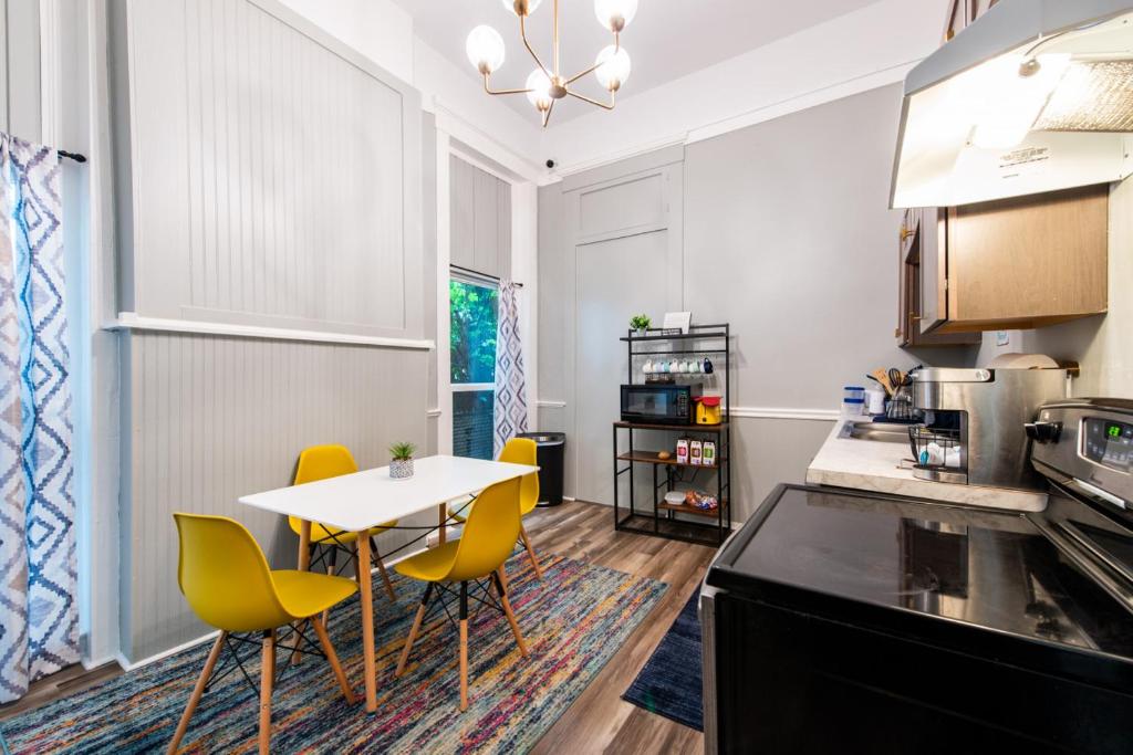 a kitchen with a table and some yellow chairs at Suite near downtown Louisville, KY - Suite VIII in Louisville