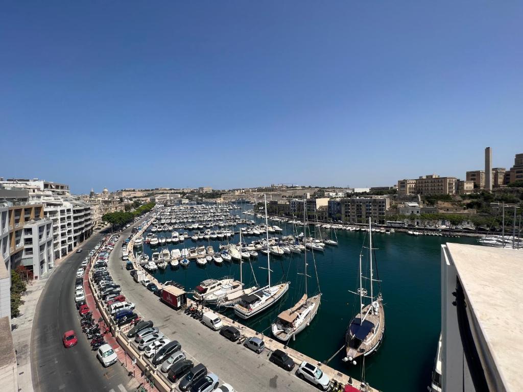 a harbor filled with lots of boats in the water at Ta Xbiex Sea Front Penthouse in Taʼ Xbiex