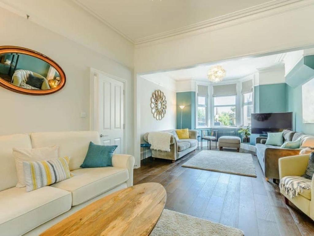 a living room with a couch and a table at Walpole House sleeps 19-24 in Margate