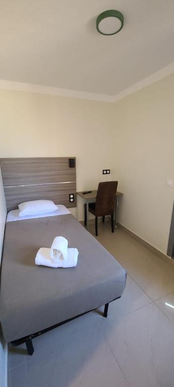 Postel nebo postele na pokoji v ubytování ESPERANCE HOTEL