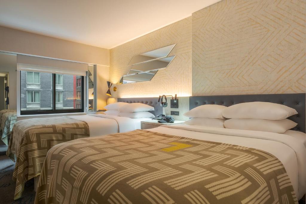Postel nebo postele na pokoji v ubytování Pestana CR7 Times Square
