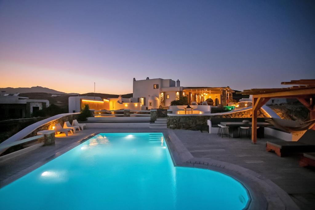 a swimming pool in front of a villa at night at Villa Surfland in Elia