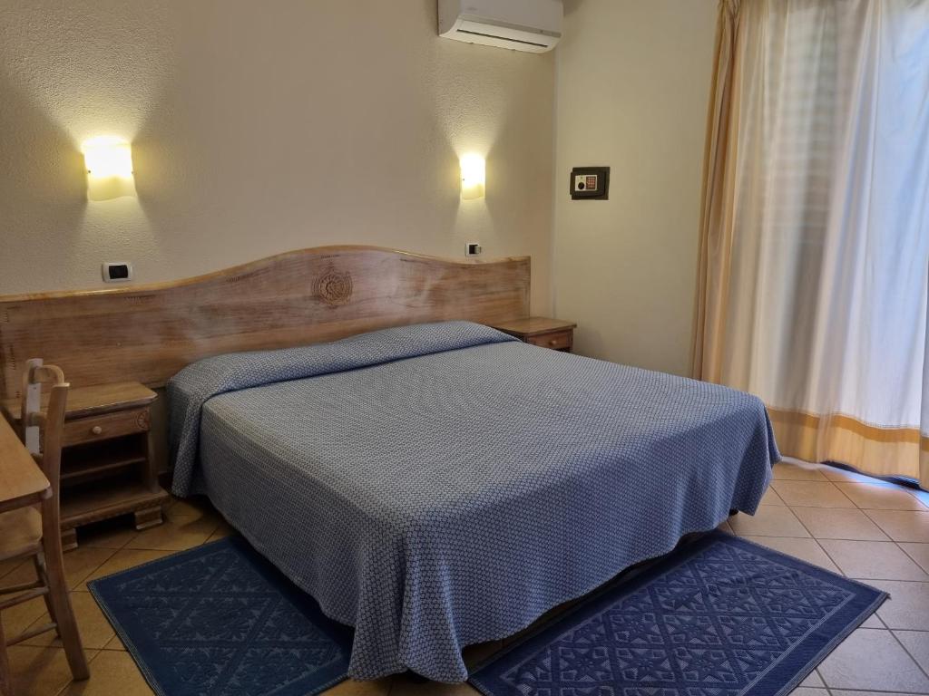 Łóżko lub łóżka w pokoju w obiekcie Hotel Delle Isole