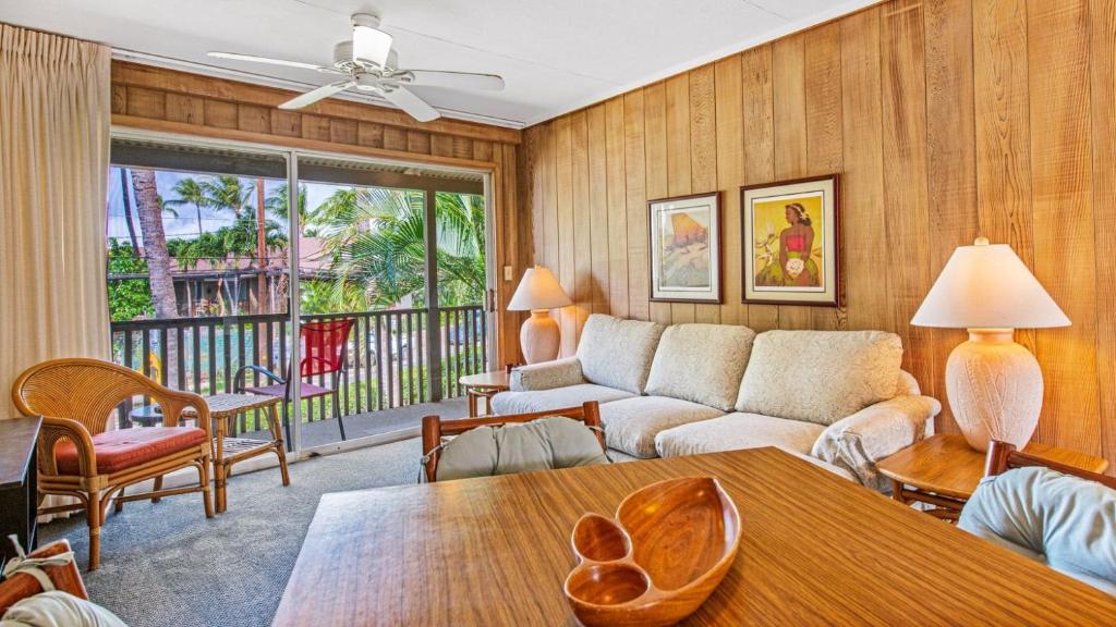 a living room with a couch and a table at Exquisite Honokowai Palms Unit #A-7 in Kahana