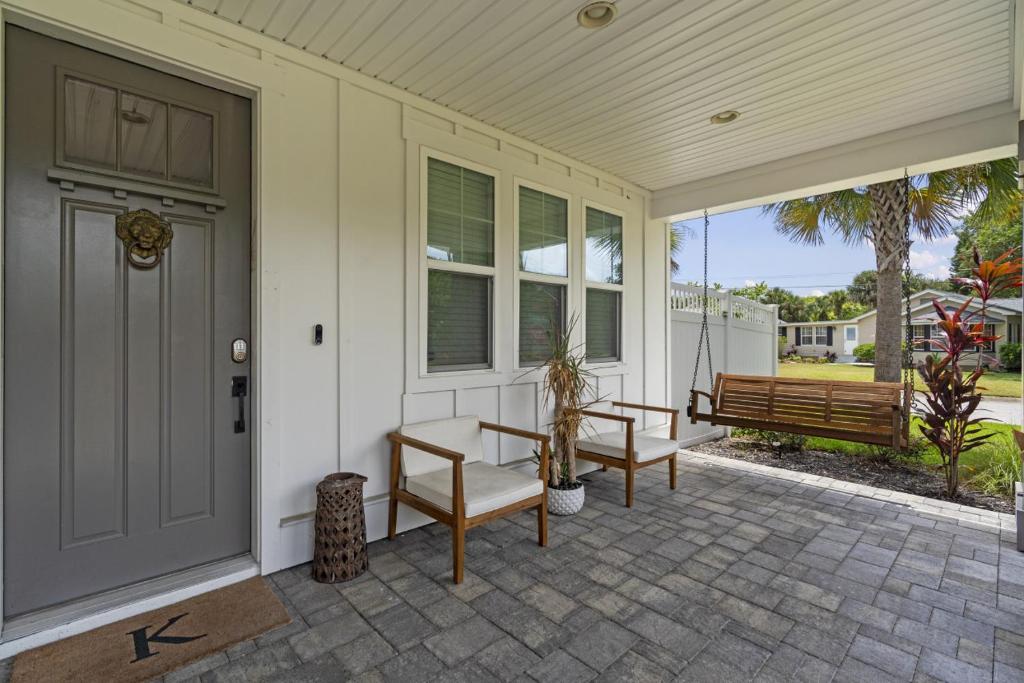 a front door of a house with a table and benches at The White House Island,Beach,Hot Tub,Downtown in St. Augustine