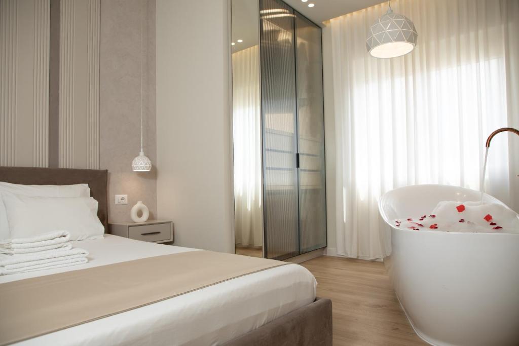 a bedroom with a bath tub and a bed at Comfort Apartament 27 in Durrës