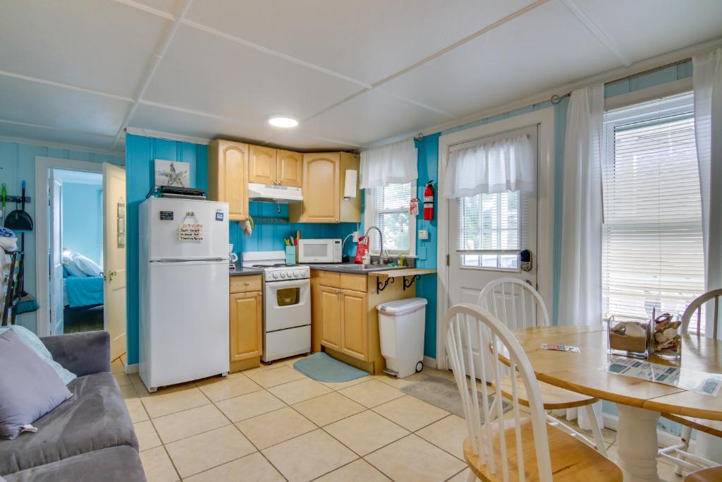 a kitchen with a table and a white refrigerator at Ocean City Retreat Near Theme Parks, Walk to Beach in Ocean City