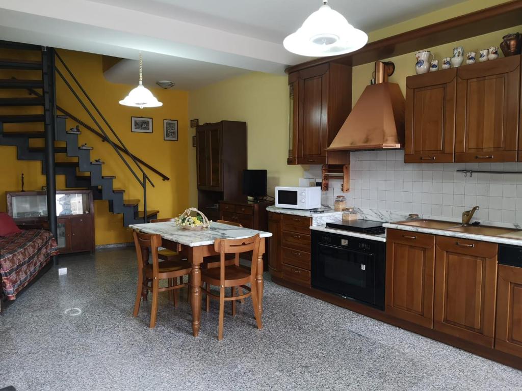 een keuken met een tafel en een fornuis top oven bij Casa Manzoni Abriola in Abriola