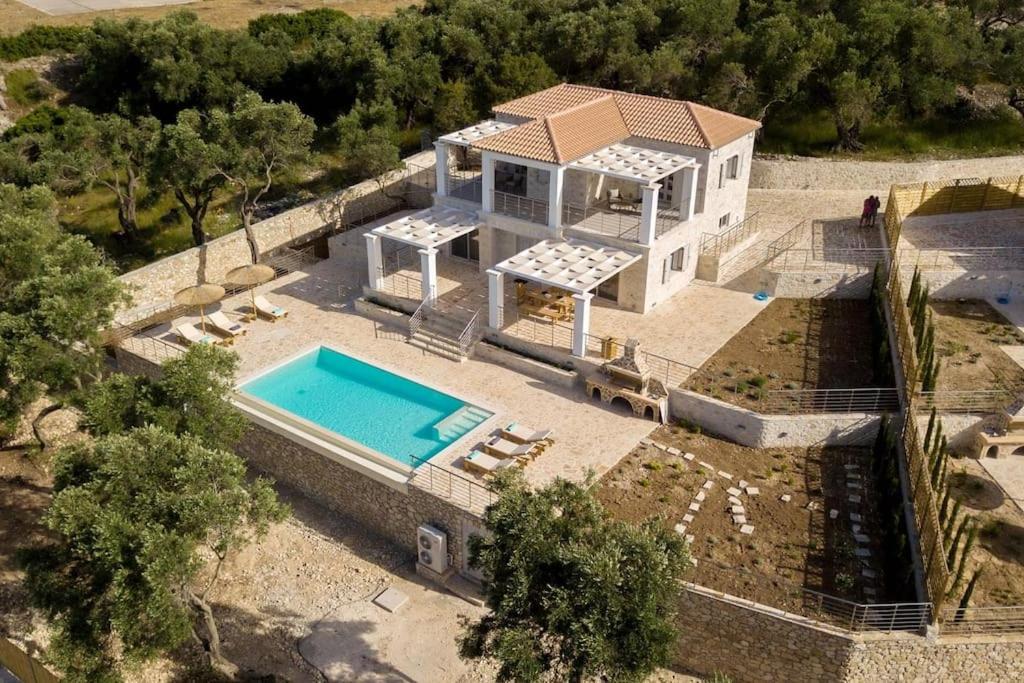 an aerial view of a house with a swimming pool at Tania Villa by PaxosRetreats in Gaios
