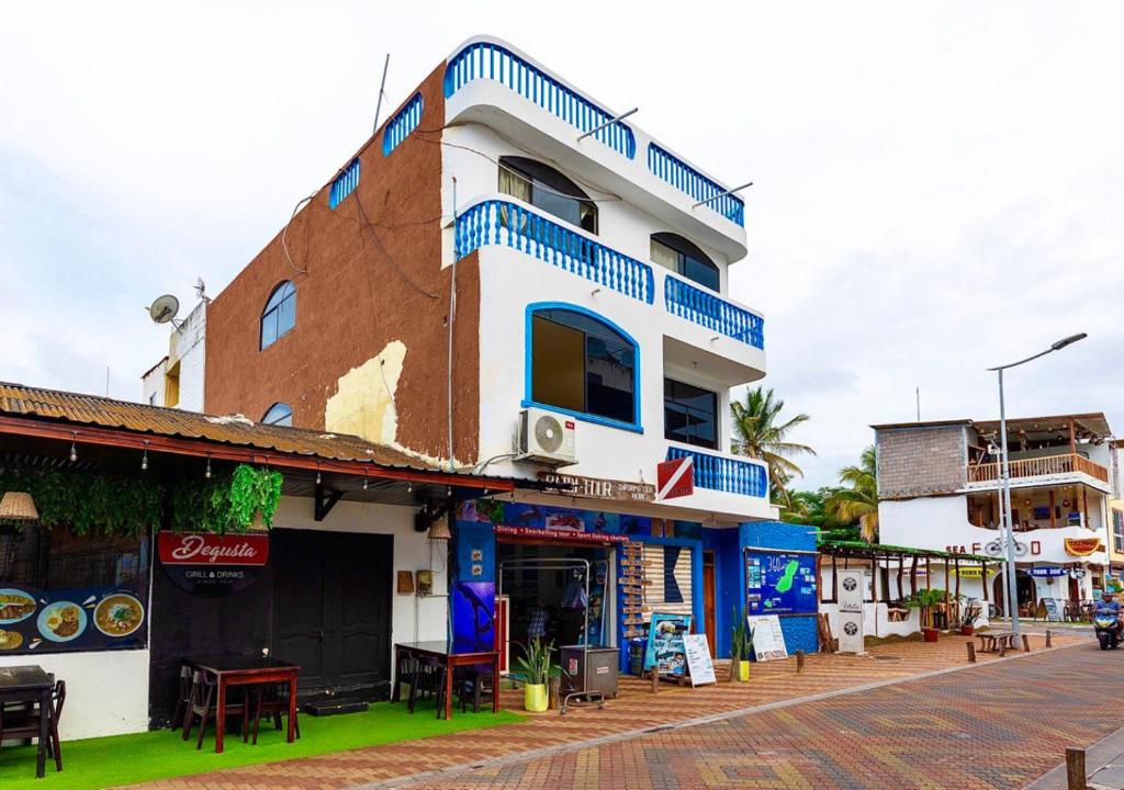 a building with blue accents on a street at Blue Horizon, Galápagos in Puerto Baquerizo Moreno