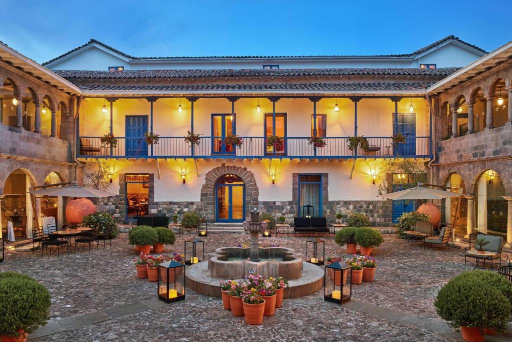 a large building with a courtyard with a fountain at Palacio del Inka, a Luxury Collection Hotel, Cusco in Cusco