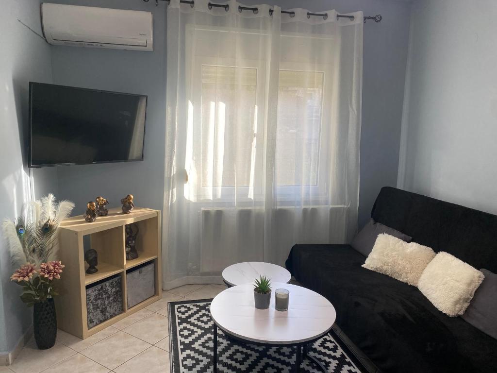 a living room with a couch and a table at Maria's Central Apartment in Igoumenitsa