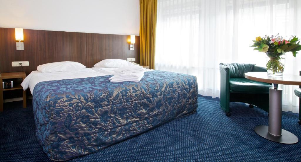Postel nebo postele na pokoji v ubytování Hampshire Hotel Petit Nord