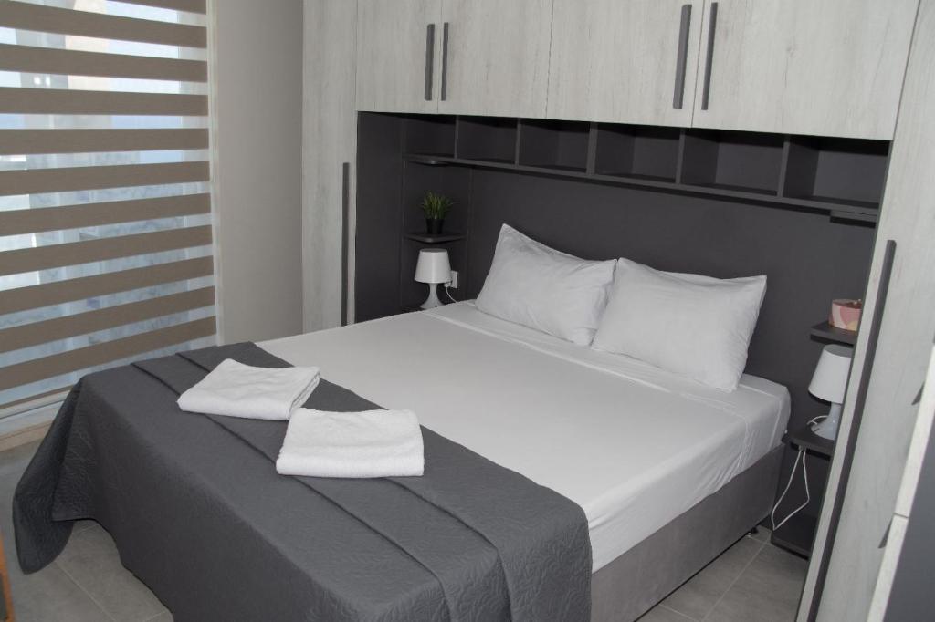 a bedroom with a bed with two towels on it at Graziosa Penthouse in Il-Ħamrija