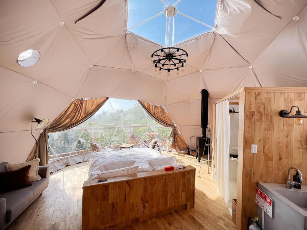 a bedroom in a tent with a large window at KnotDaisen - Vacation STAY 98739v in Daisen
