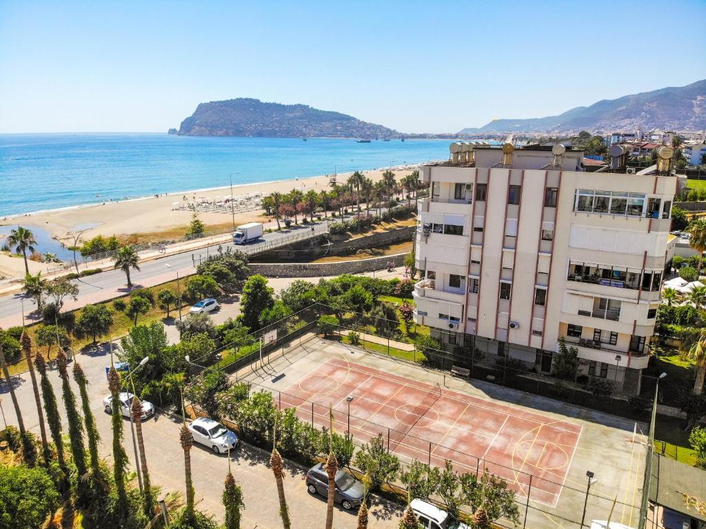 an aerial view of a beach and a building at Sunny Apartment with Fabulous Sea View in Alanya