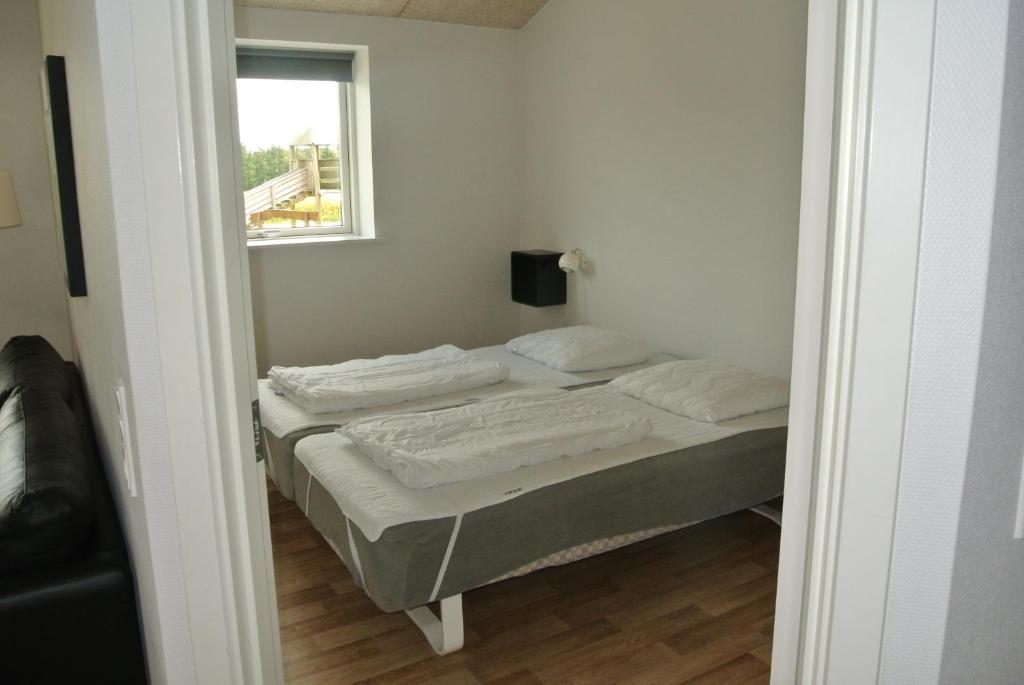 Postel nebo postele na pokoji v ubytování Fitting Landsbyferie Apartments