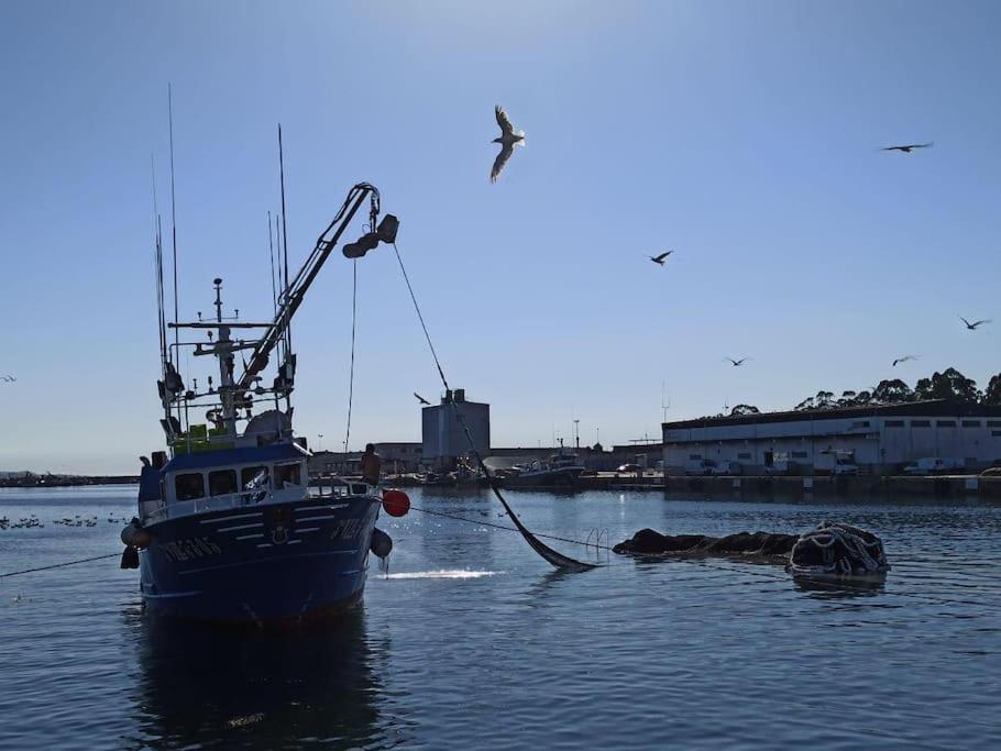 a boat is docked in a body of water at Apto Solpor, terraza y parking in Cambados