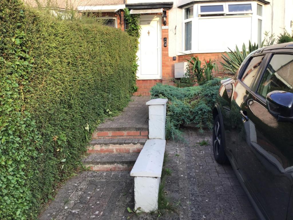a stairway with a car parked in front of a house at Stay near Southmead Hospital and Airbus in Bristol
