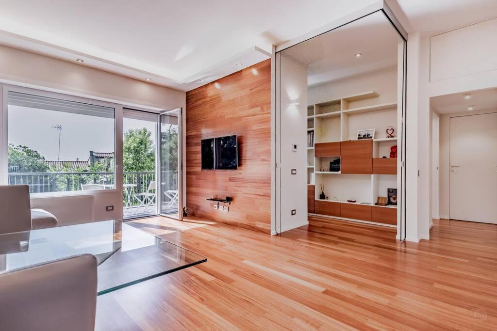 an empty living room with a desk and a large window at Luxury apartment front of Cavalieri Hilton Hotel in Rome