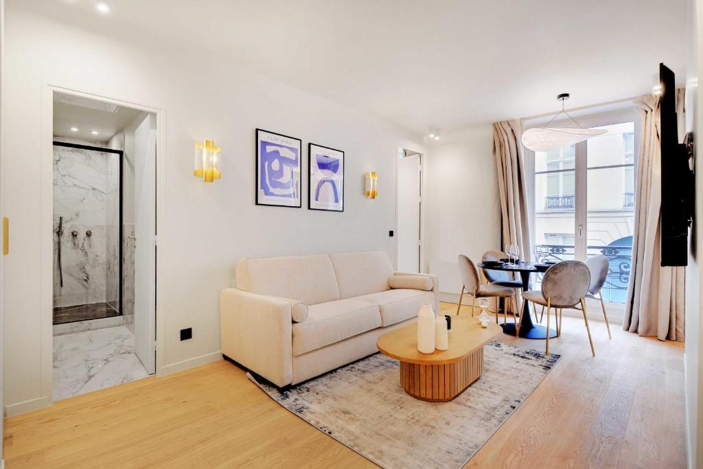 un salon avec un canapé blanc et une table dans l'établissement Elegant apartment - 2BR 6P - Opéra, à Paris