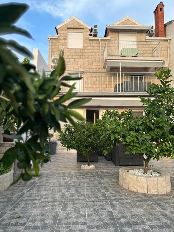 a house with two trees in front of it at Apartment Samanta in Supetar