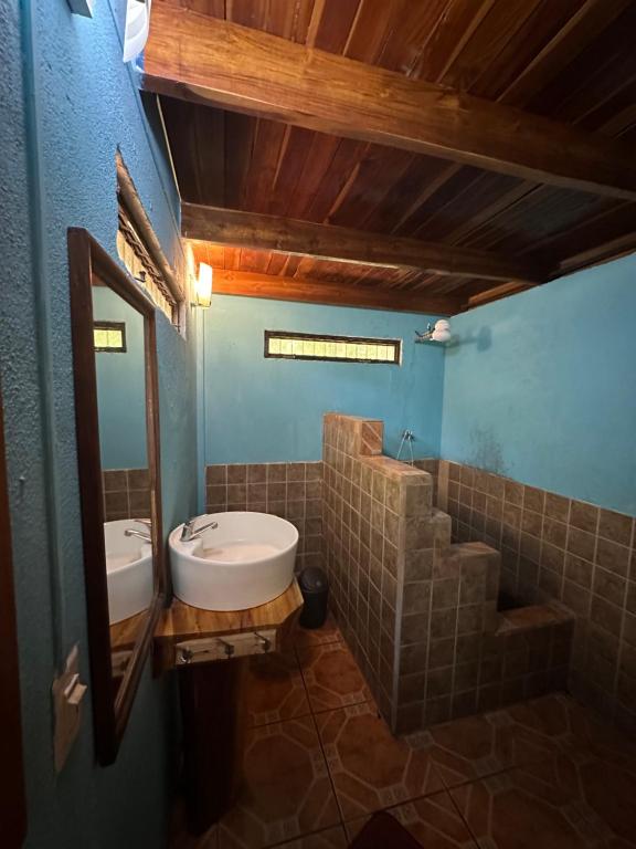 a bathroom with a sink and a mirror at Aldos place in Playa Negra