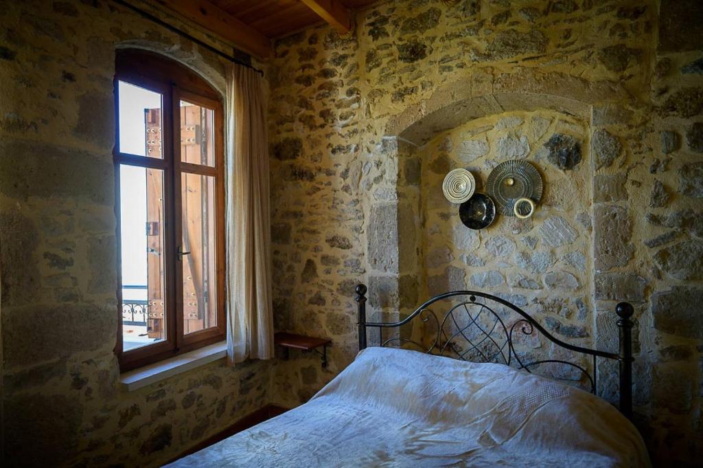 A bed or beds in a room at Traditional Stone Mezonete
