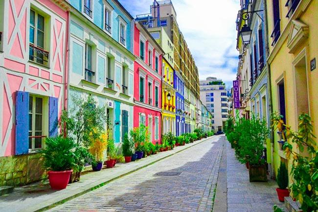 a street with colorful buildings and potted plants at Paris in Settat