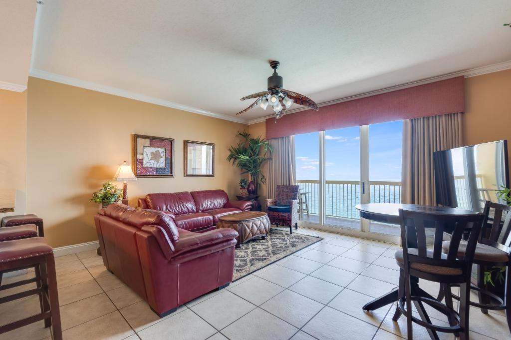 a living room with a couch and a table at Calypso Resort - Direct gulf front Condo with king master, and Free Wi-Fi in Panama City Beach