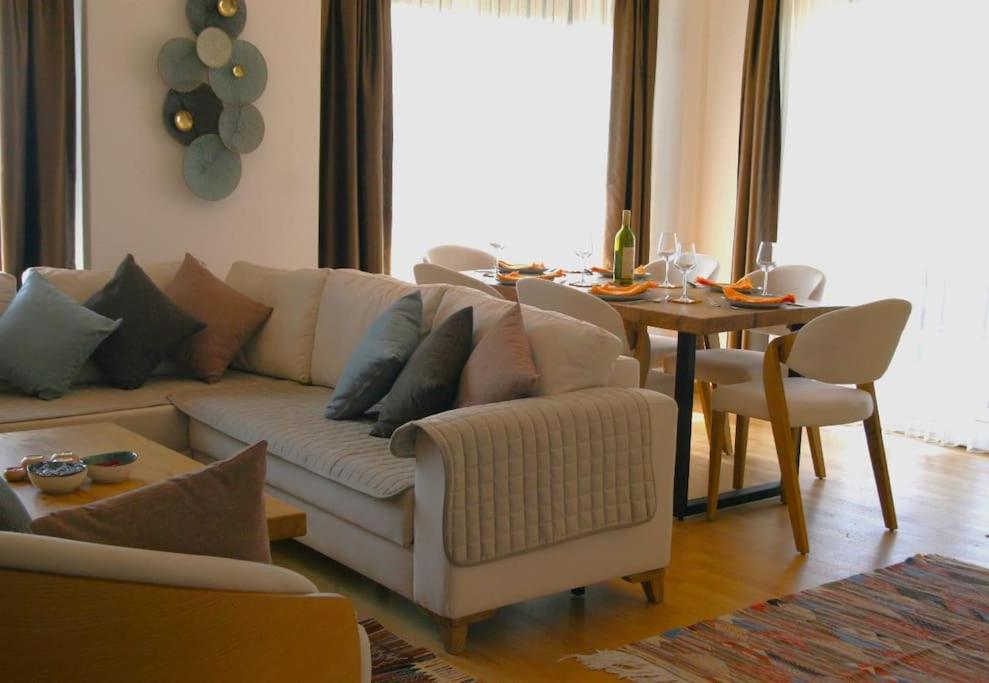 a living room with a couch and a dining table at The Olive Trees Penthouse - two bedroom in Bar