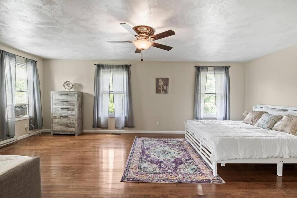 a bedroom with a bed and a ceiling fan at Large Home Sleeps 24! Dogs Ok! in Lansing