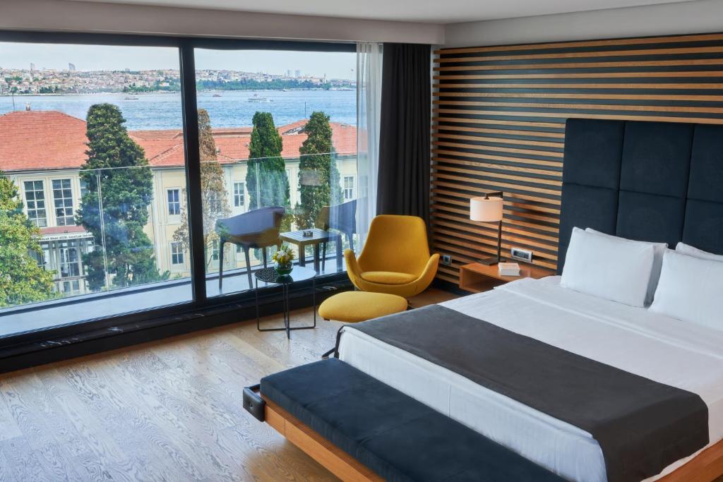 a hotel room with a bed and a large window at Metropolitan Hotels Bosphorus - Special Category in Istanbul