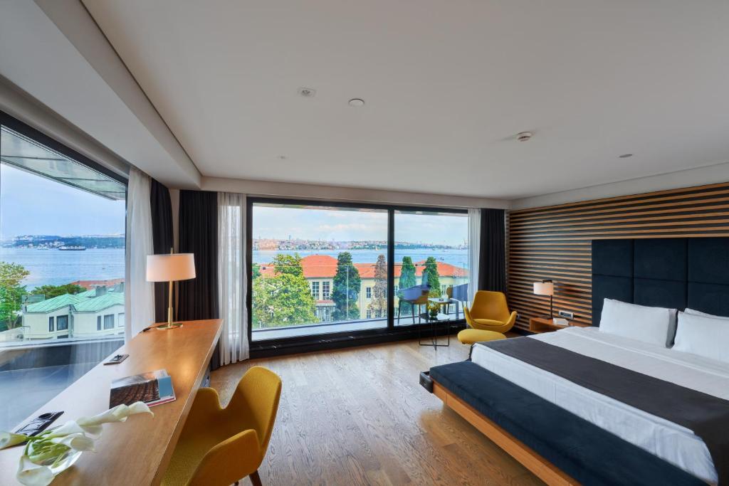 um quarto de hotel com uma cama e uma grande janela em Metropolitan Hotels Bosphorus - Special Category em Istambul