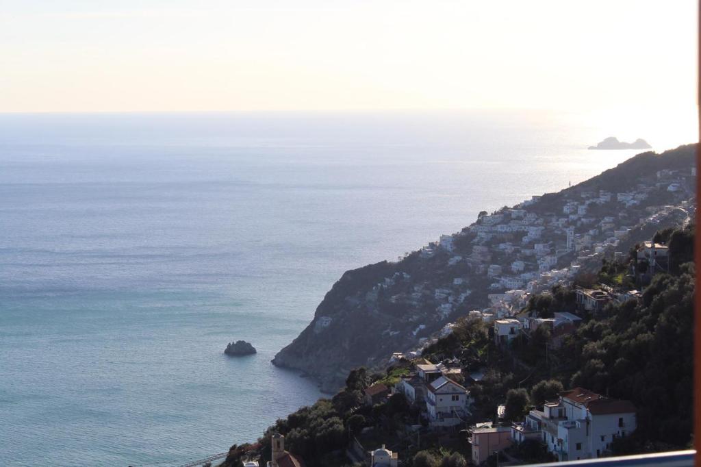 a town on a hill next to the ocean at Da Nonna Nicoletta in Furore