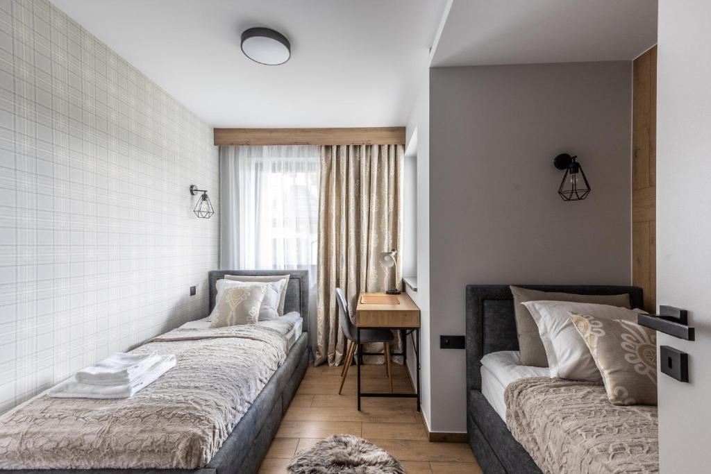Ένα ή περισσότερα κρεβάτια σε δωμάτιο στο Apartament Górski Zakątek - Białka Tatrzańska - na terenie obiektu Sun&Snow