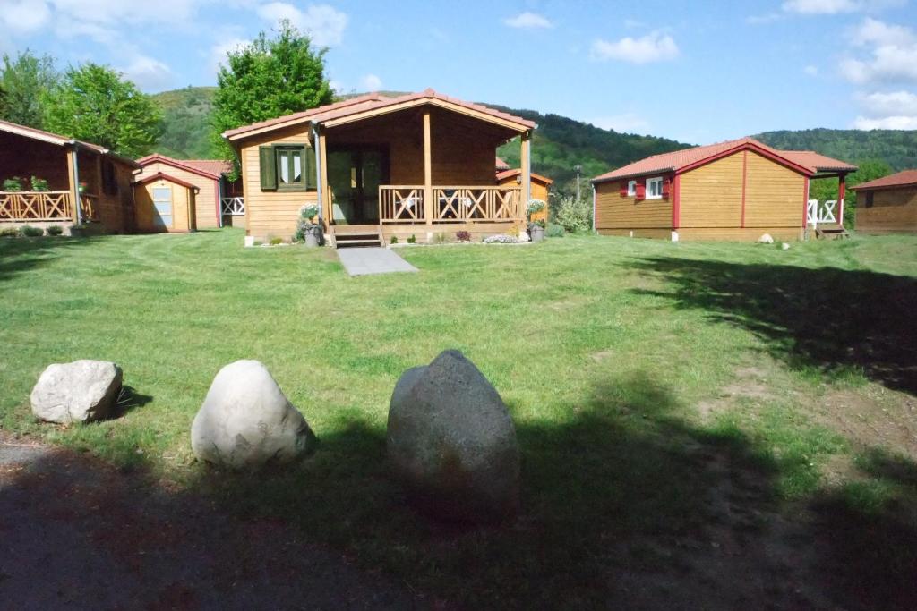 a cabin in a field with rocks in the grass at Chalet Hertzland in Ranspach