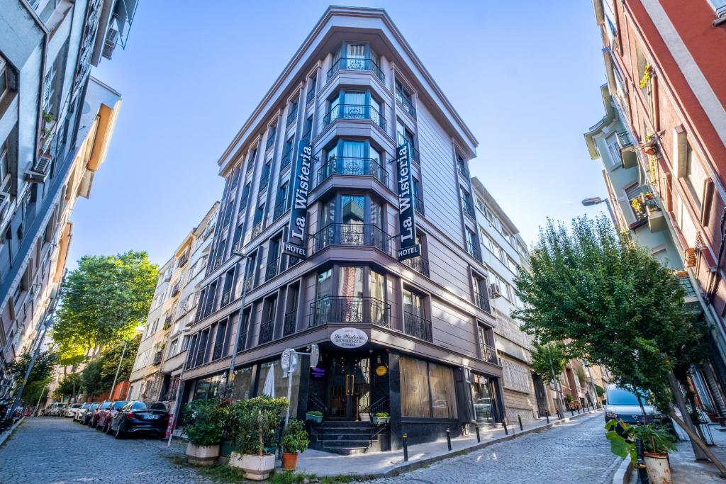 a tall building on a street in a city at La Wisteria Boutique Hotel Istanbul in Istanbul