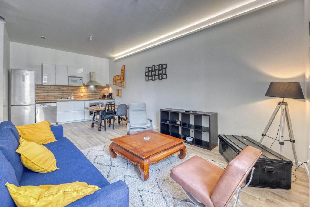 - un salon avec un canapé bleu et une table dans l'établissement Le Family's 39 - CHU, à La Tronche