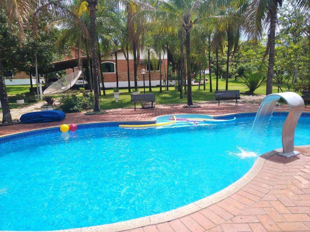 a swimming pool with a water slide in a park at Chalés Holiday House in Rio Quente